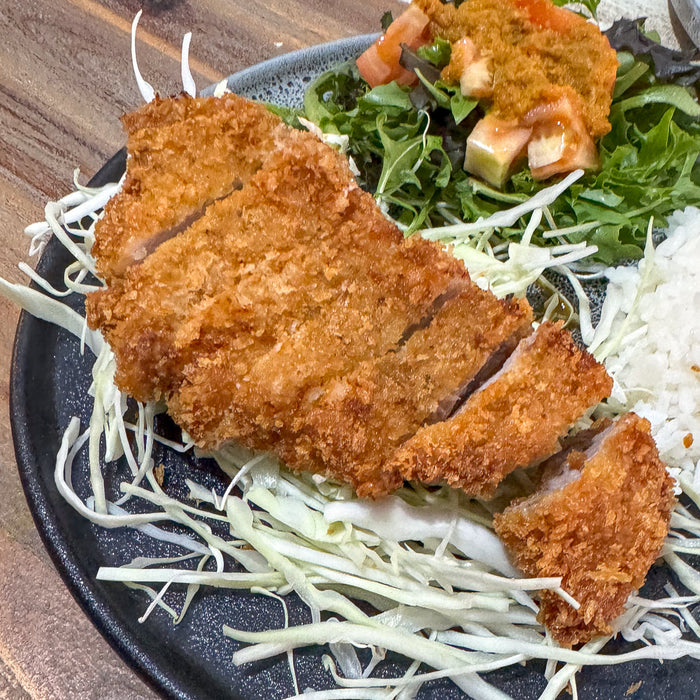 Tonkatsu meal with pork, cabbage, rice and salad